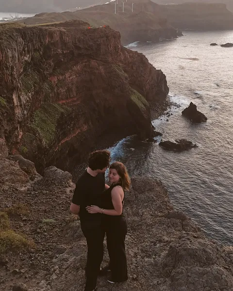Kristi Leka on a green clifftop above a rocky coastline