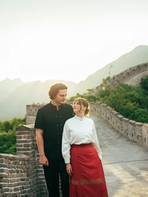 Kristi Leka standing on the Great Wall of China in low golden light