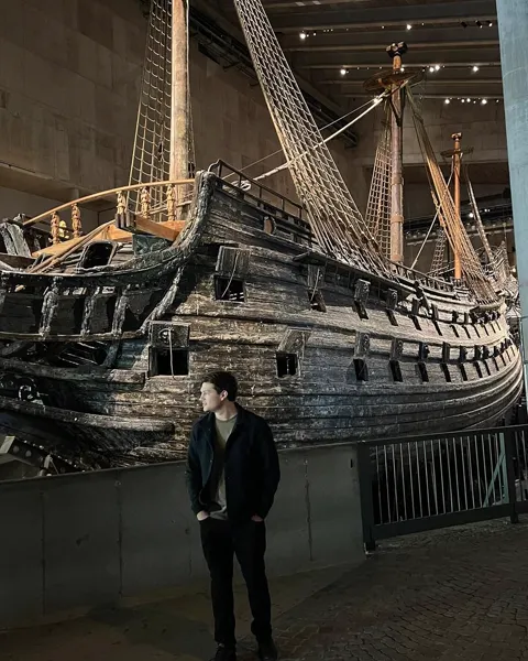 Kristi Leka standing in front of the seventeenth-century warship Vasa at the Vasa Museum in Stockholm, Sweden