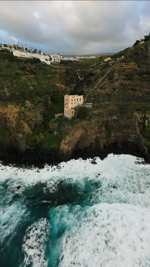 Aerial view of coastal cliffs with white surf and turquoise water, Tenerife